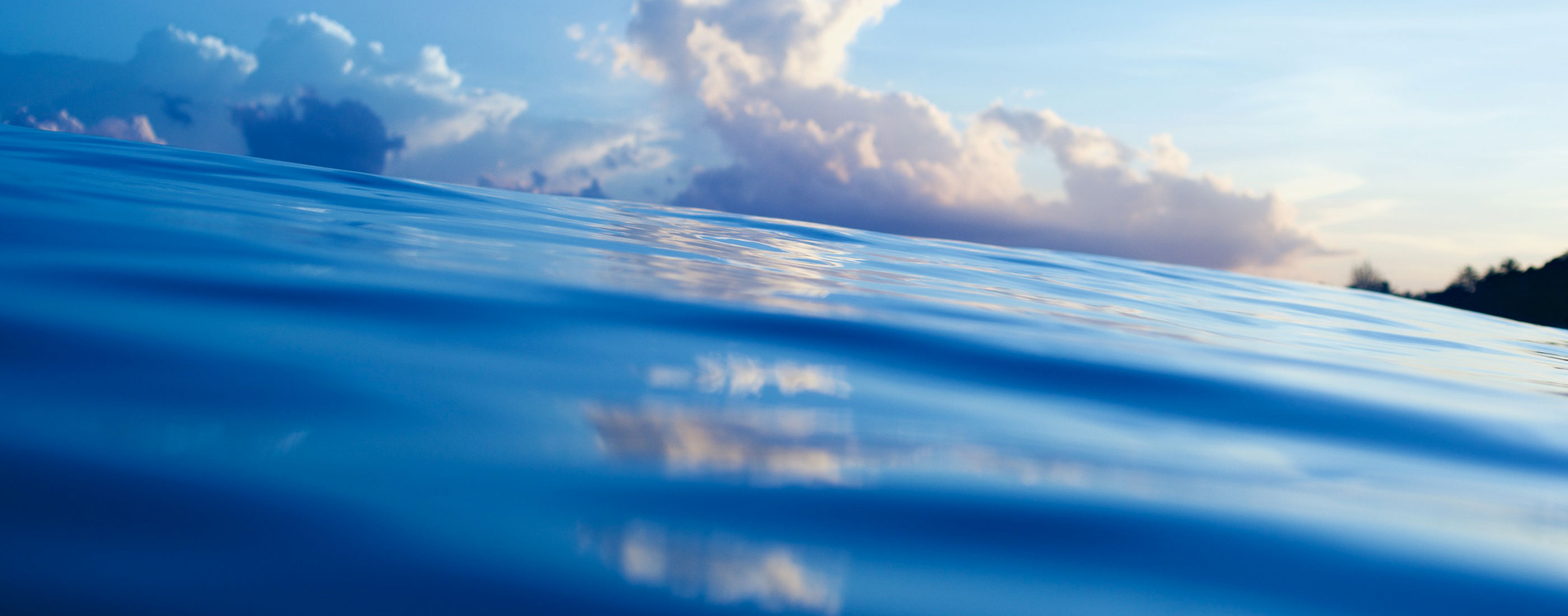 Clouds sit just behind the surface of the ocean water